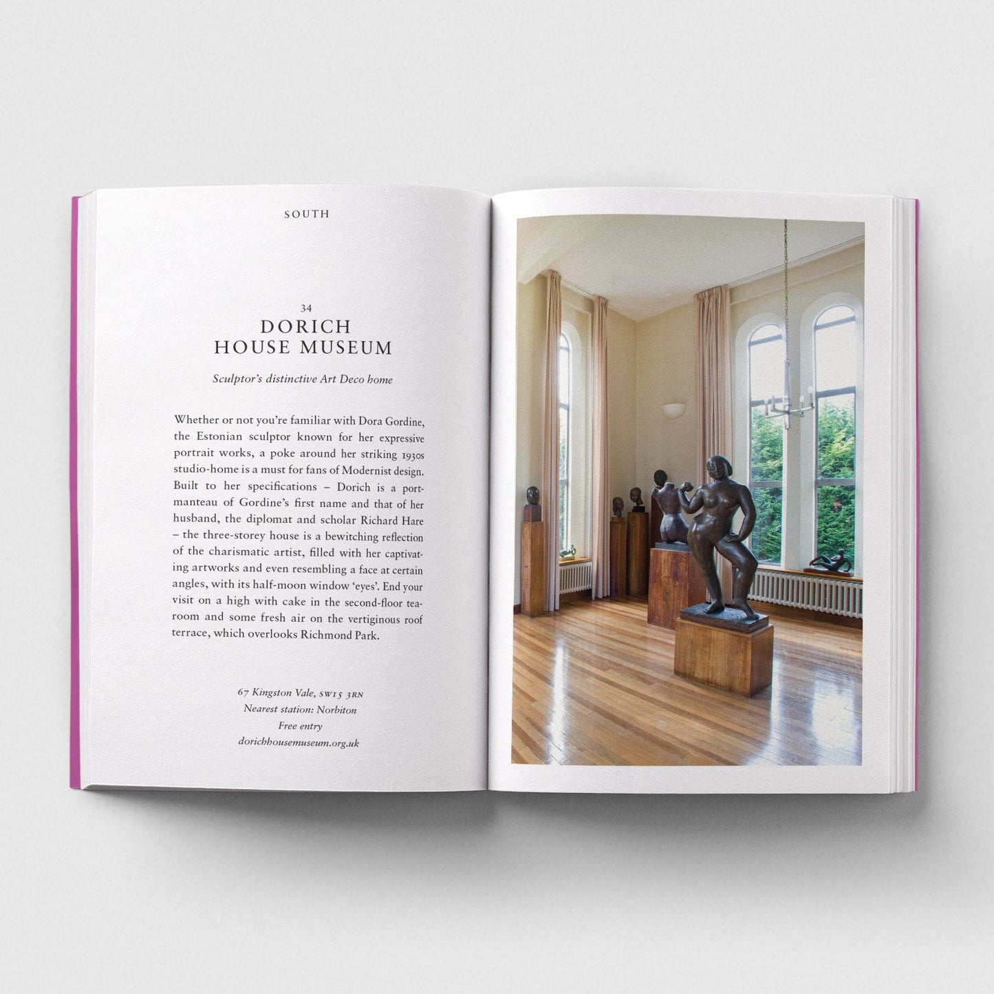 Open book showing a page with text and an image of a room with sculptures.