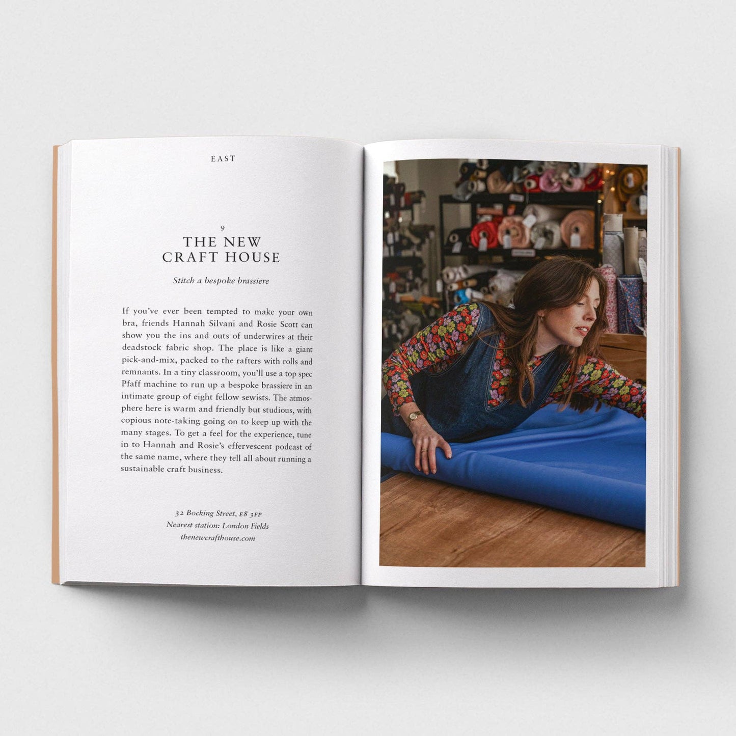 Open book with text and a photo of a woman in a store.