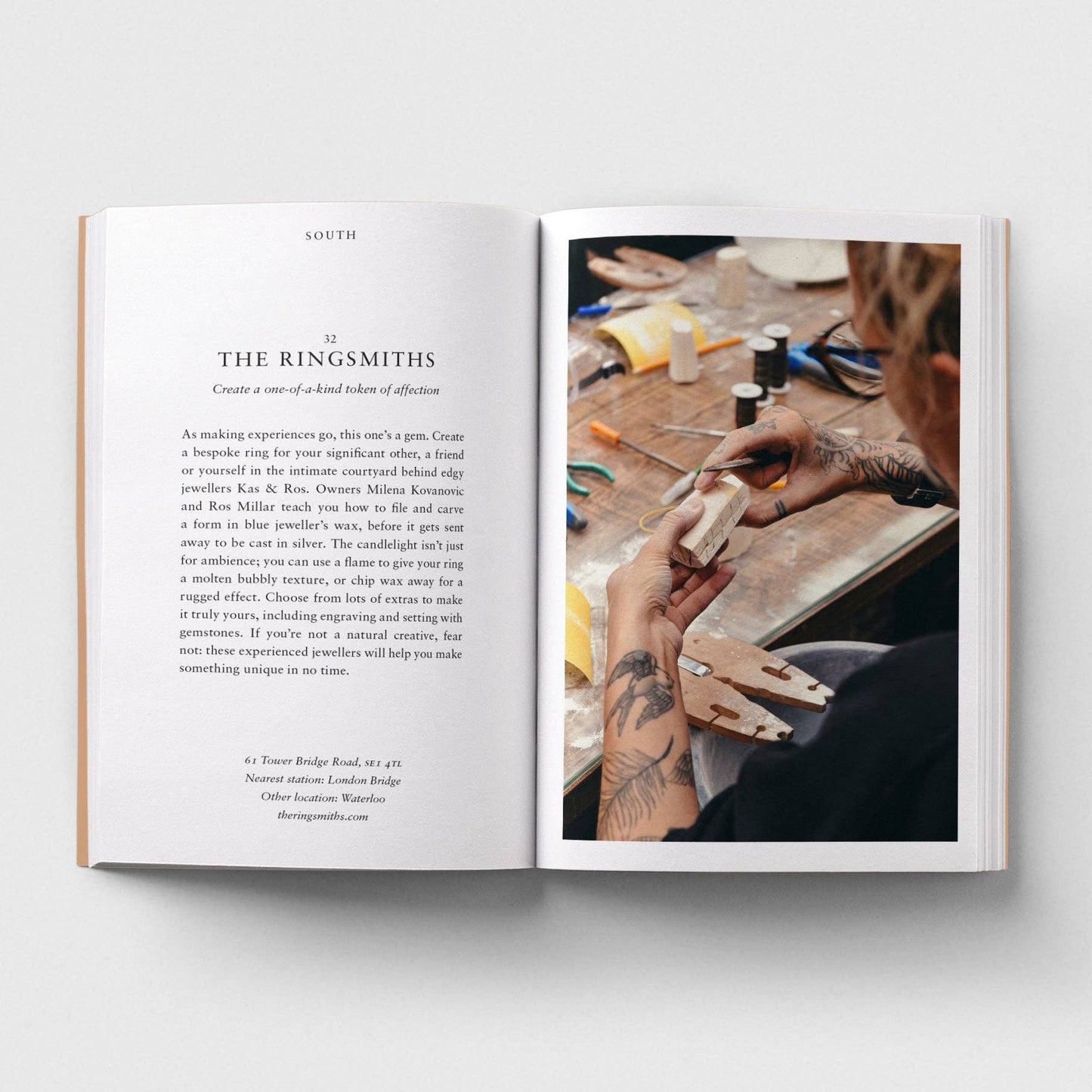 Open book showing text on one page and a photo of hands working with tools on the other, on a white background.