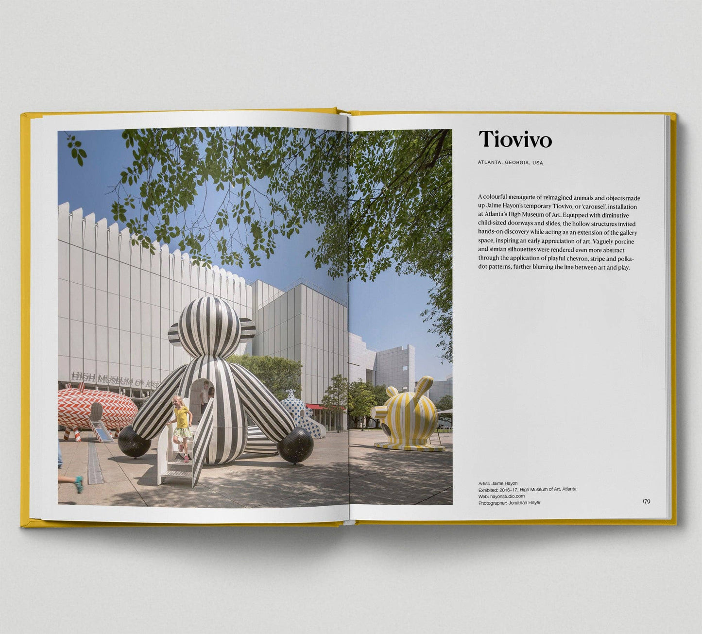 Open book showing a page with an image of a sculpture and text on a white background