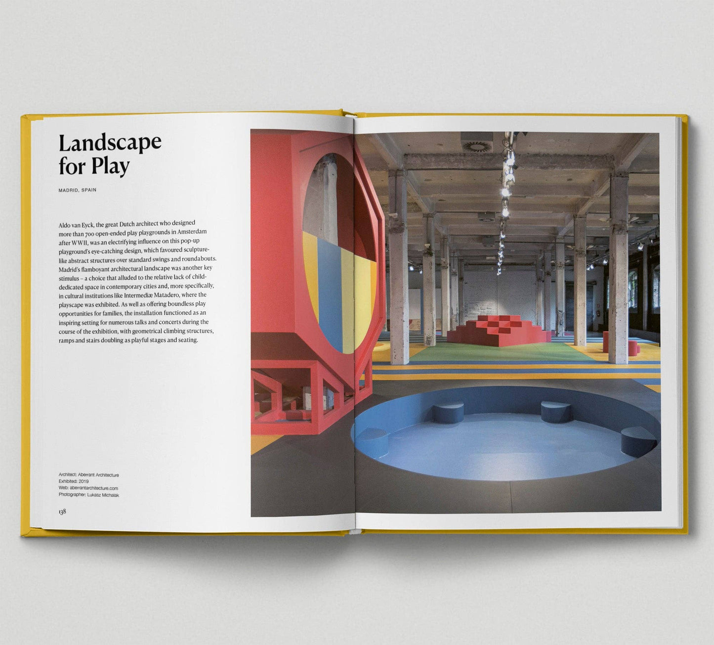 Open book showing a colourful indoor play area with text on the left page.