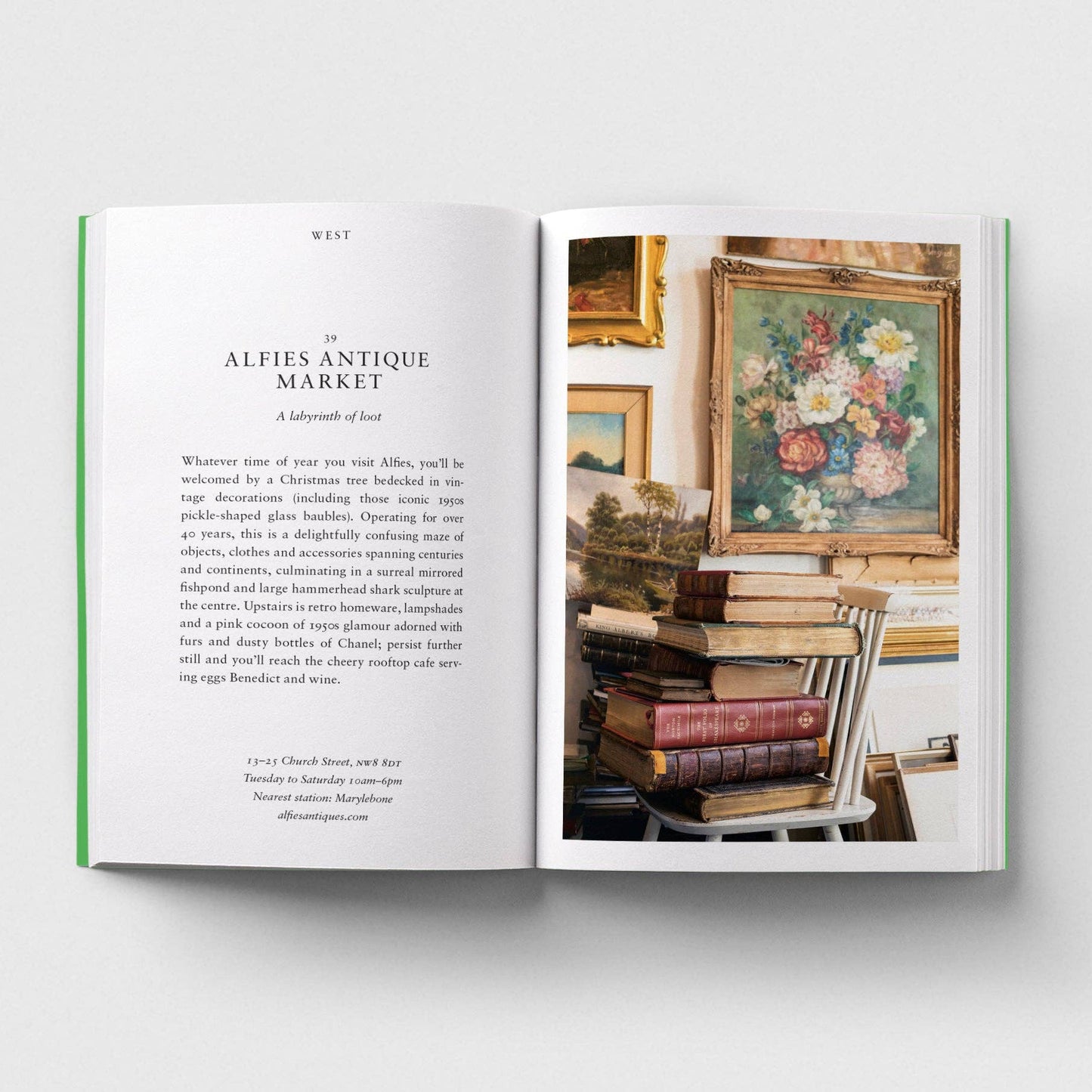 Open book showing a page with text and an image of a floral painting and books.