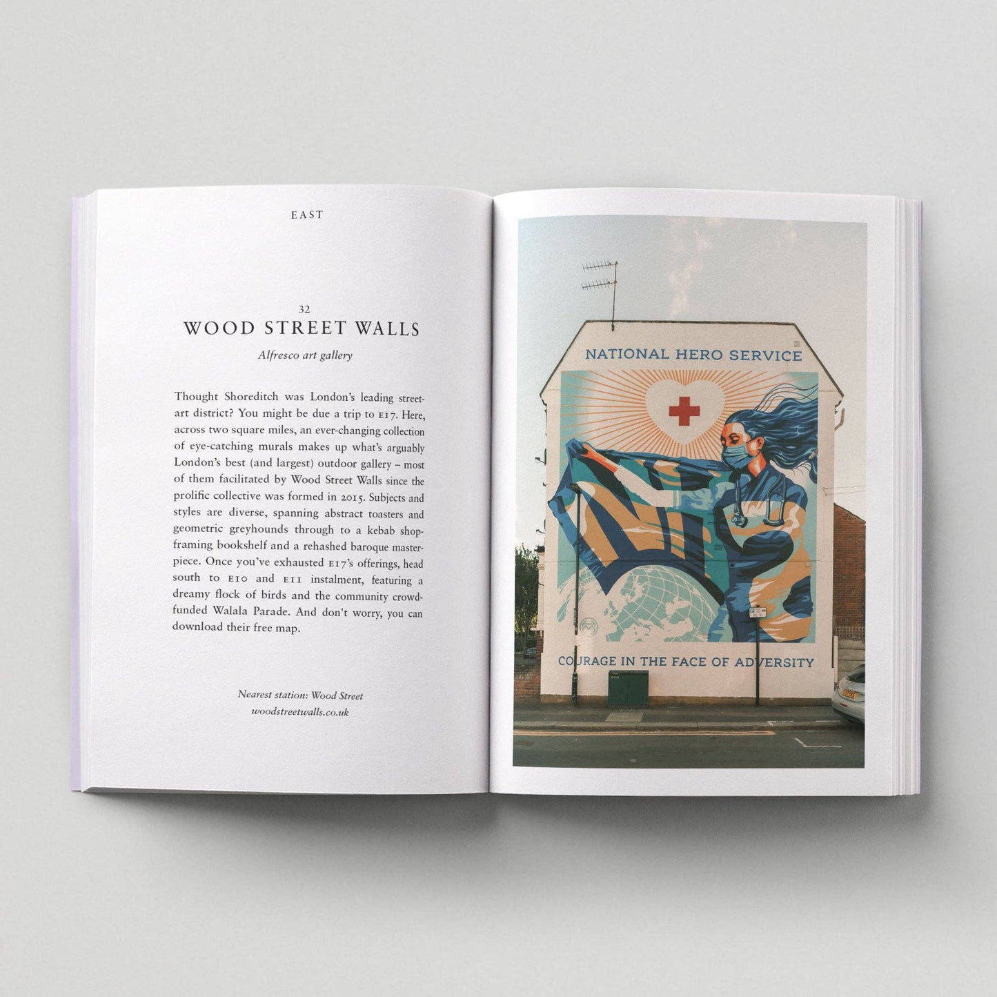 Open book showing a page with text and an image of a mural on a wall.
