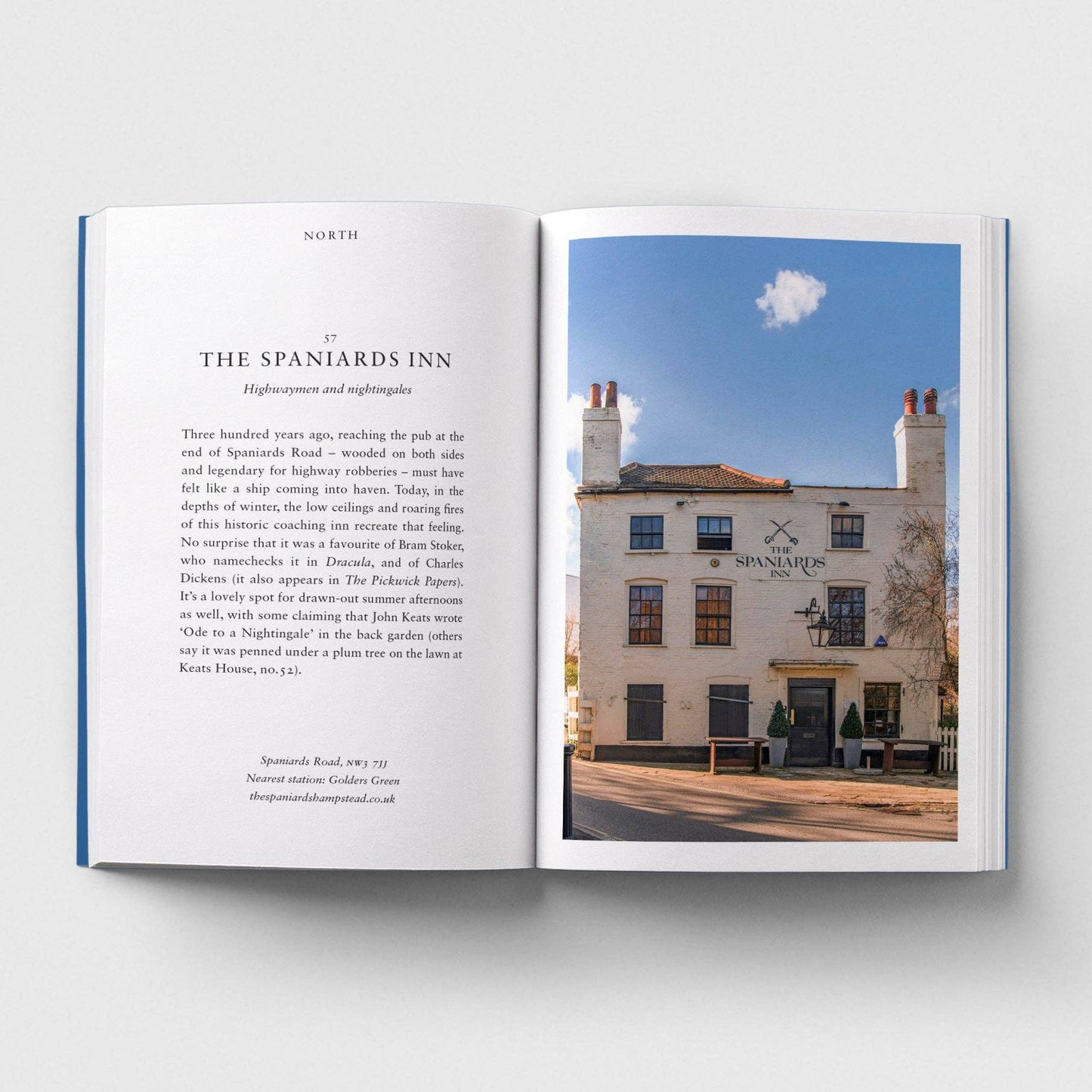 Open book showing text and a photograph of The Spaniards Inn on a white background