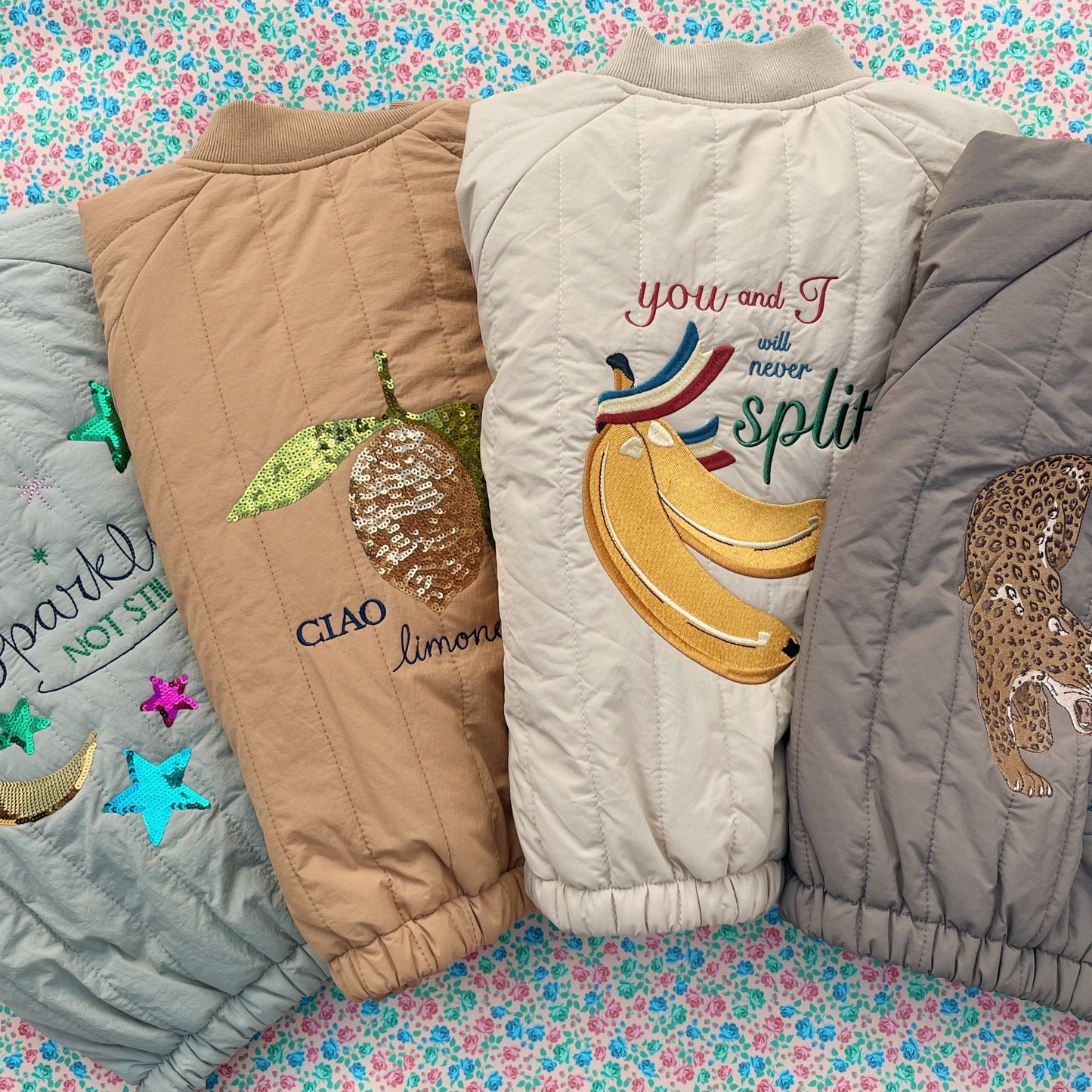Four colorful quilted items with various designs on a floral background