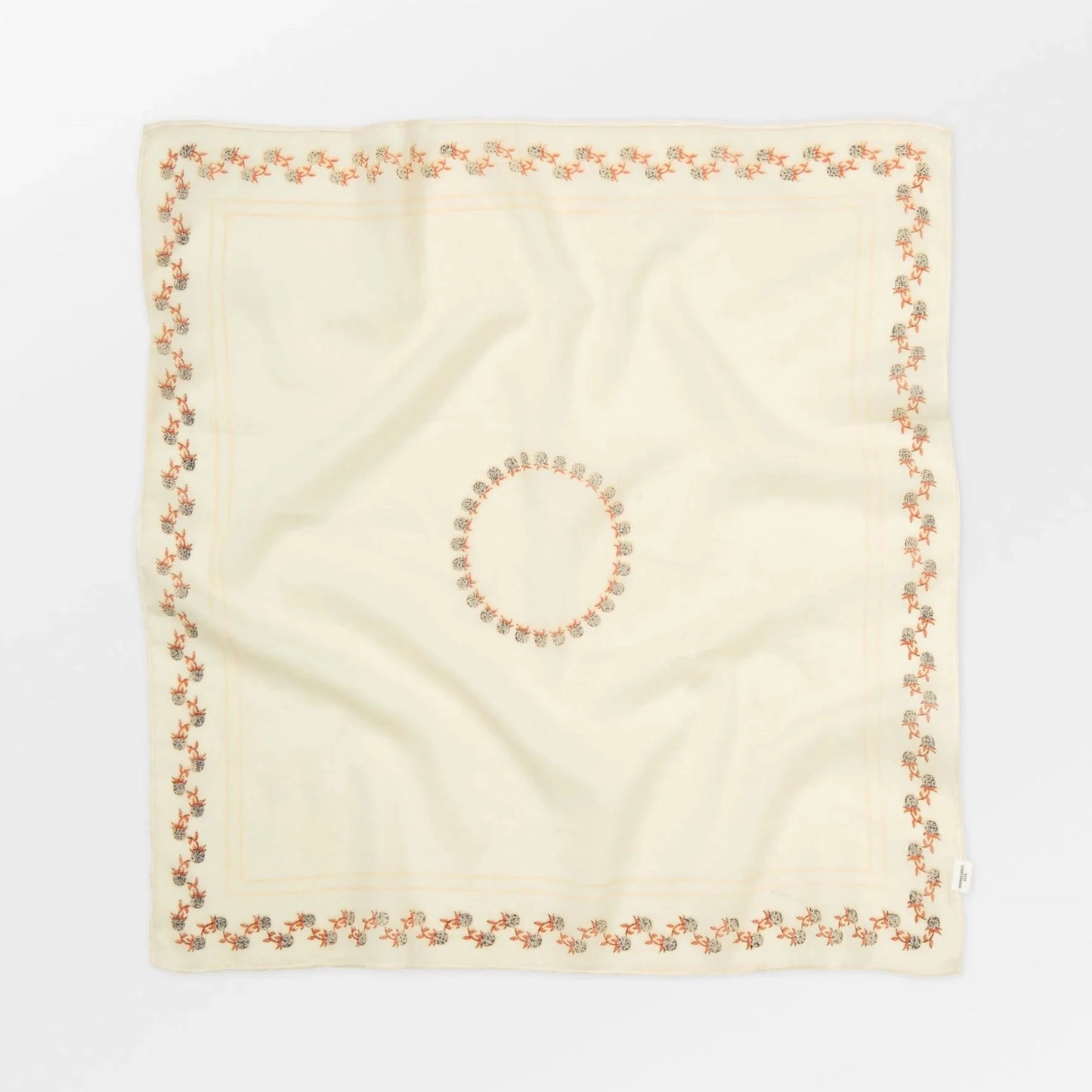 Beige square scarf with a circular pattern on a white background
