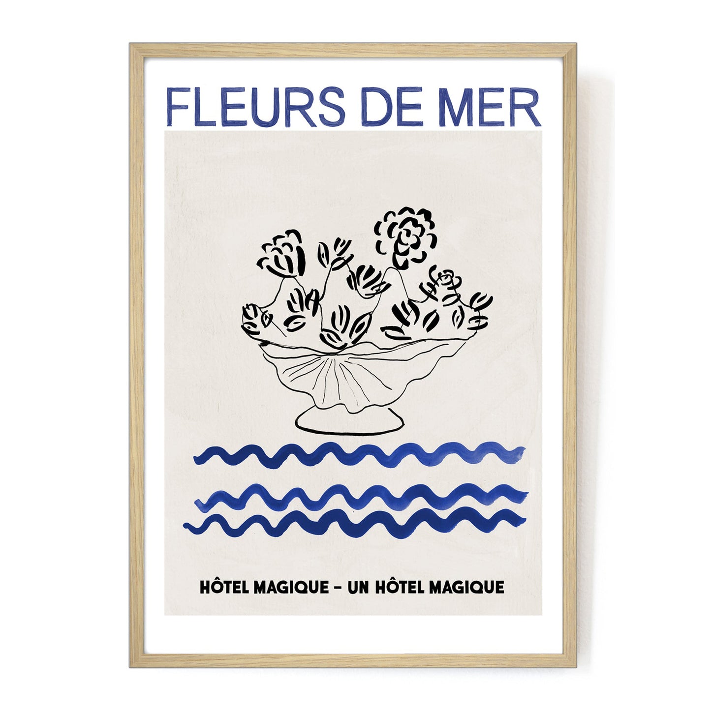 Hotel Magique Fleurs De Mers Print. The background is beige. The flowers and the flower pot is black. The waves below are dark blue in colour. “Fleurs De Mer” is written in dark blue. The print is framed.