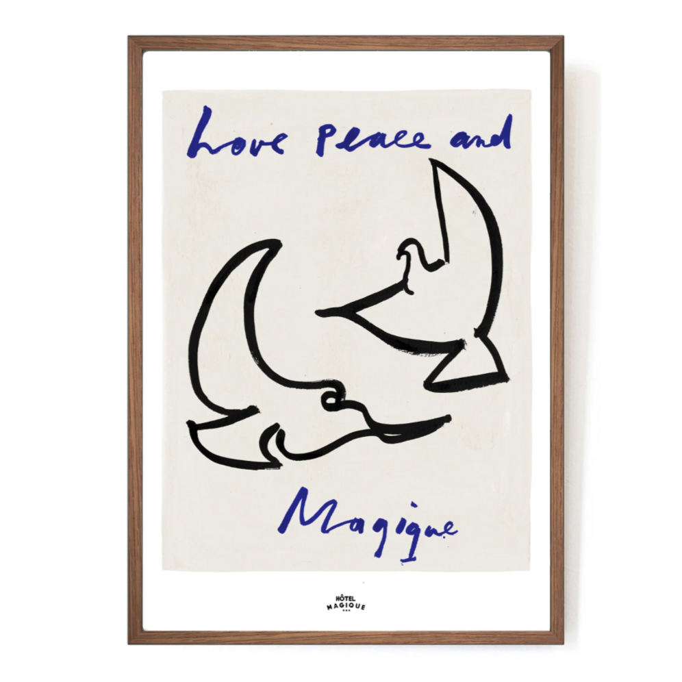 An image depicting Hotel Magique Love,Peace and Magique A3 print. The background is beige. The birds are painted in black. “Love Peace and Magique” is written in dark blue. The print is frames with a wooden border.