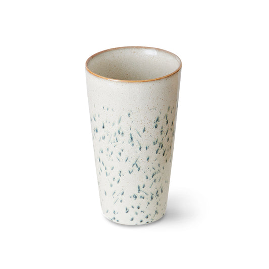 Speckled ceramic cup on a white background