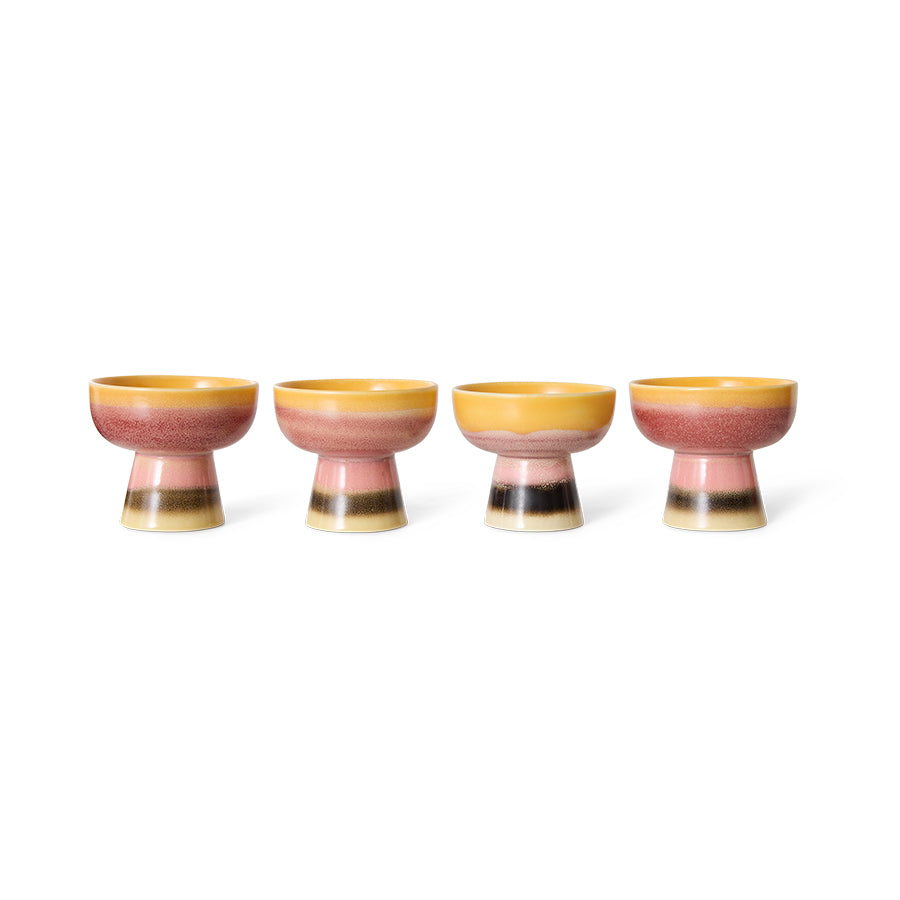 Set of four ceramic high cups with a colorful design on a white background