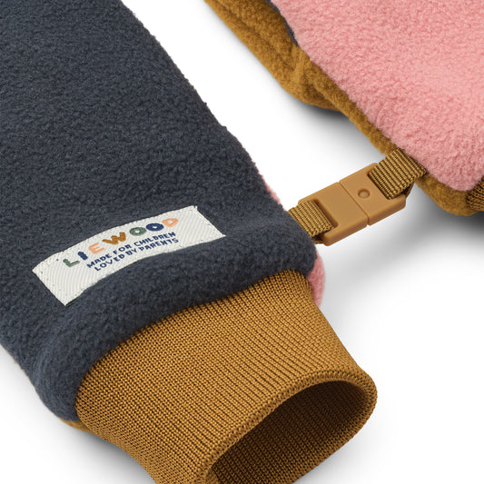 Close-up of a children's glove with a visible brand label on a white background