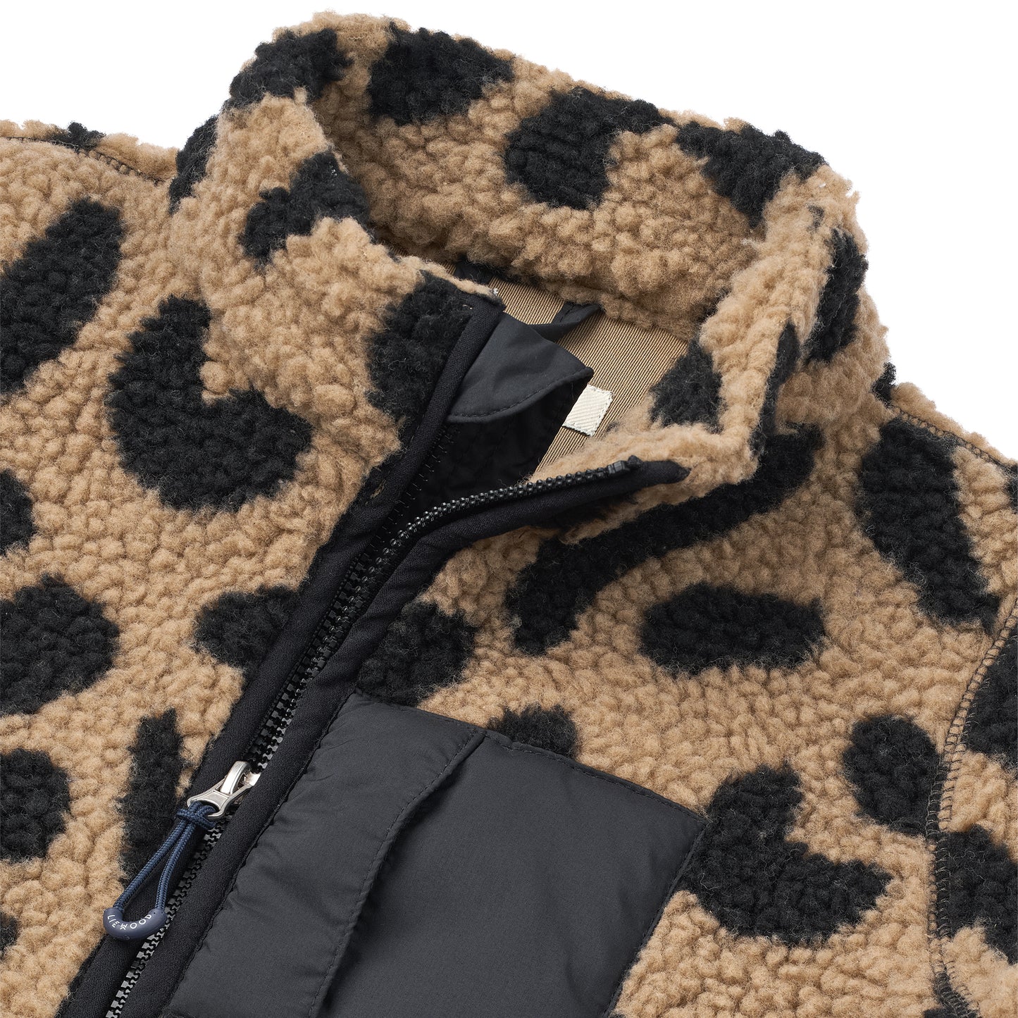 Close-up of a leopard print onesie with a black zipper on a white background