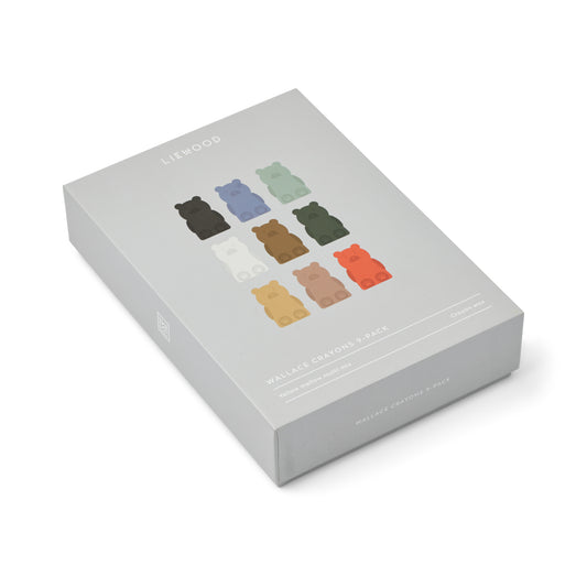 Box of colorful bear-shaped crayons on a white background