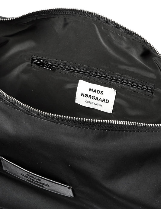 Close-up of a black bag interior with Mads Nørgaard label