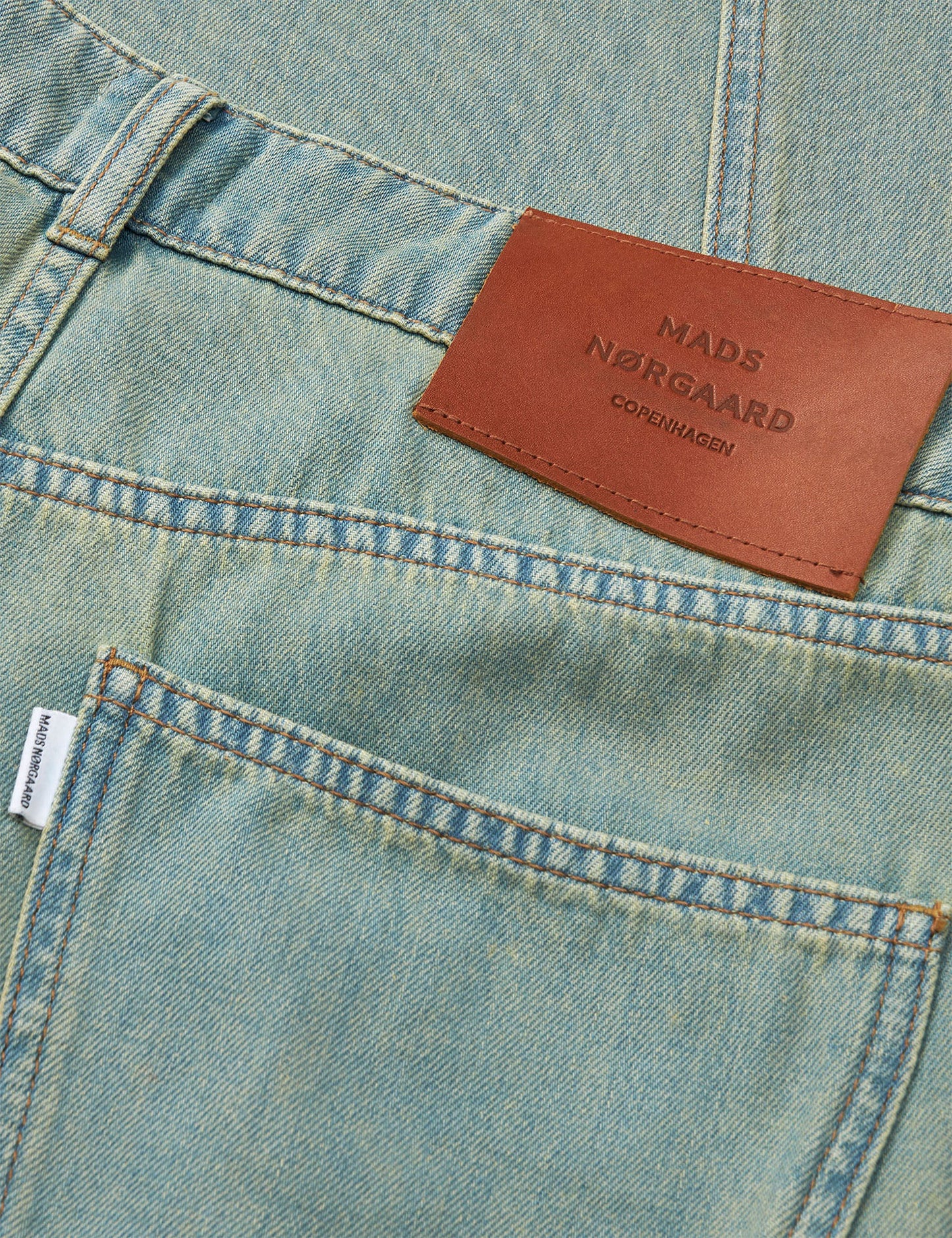 Close-up of a pair of jeans with a Mads Norgaard label.