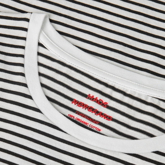 Close-up of a striped garment with 'Mads Nørgaard' branding.