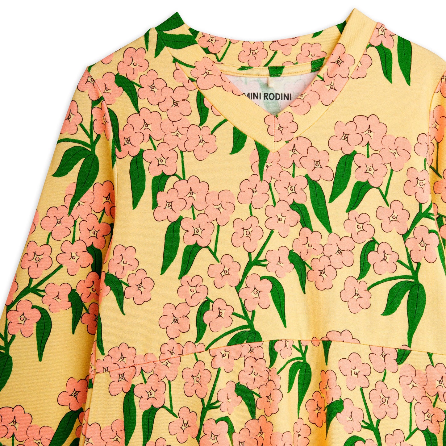Yellow shirt with pink floral pattern and 'Mini Rodini' branding.