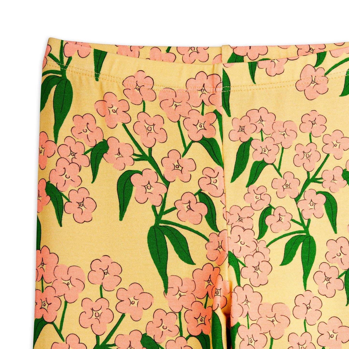 Floral patterned fabric with pink flowers and green leaves on a yellow background