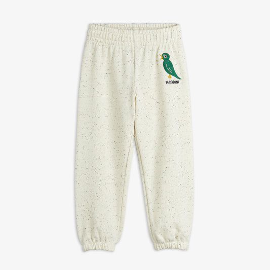 Cream-colored sweatpants with a green bird logo on a white background
