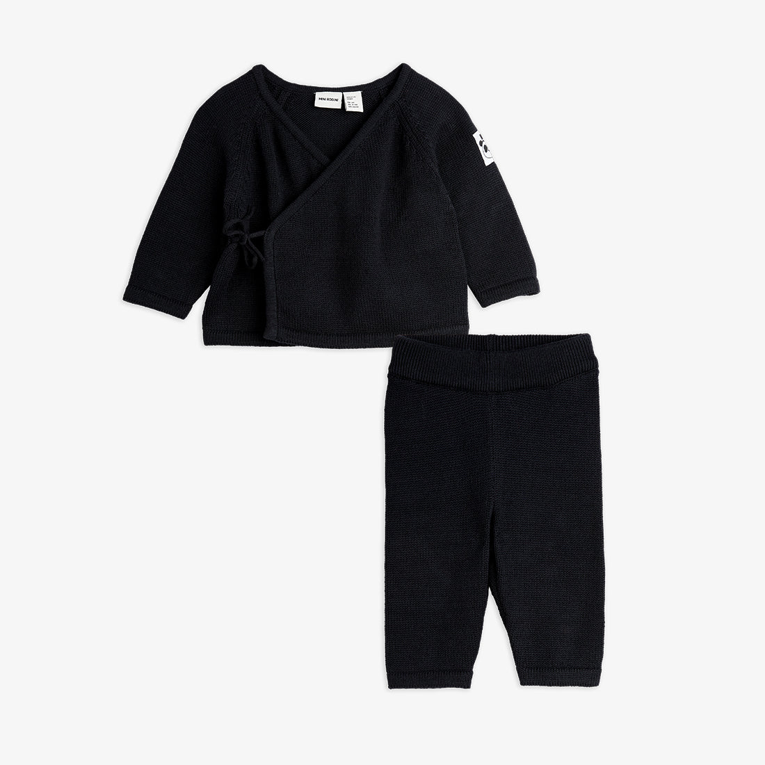 Black baby outfit with top and pants on a white background