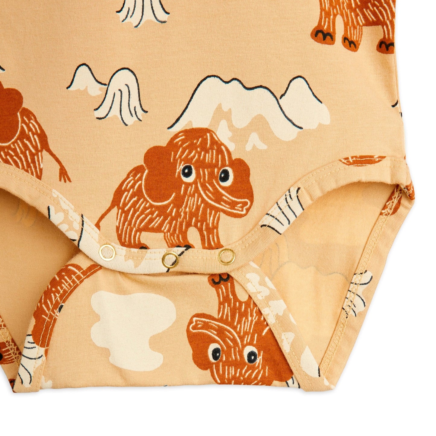 Close-up of a fabric with mammoth pattern on a beige background on a baby body