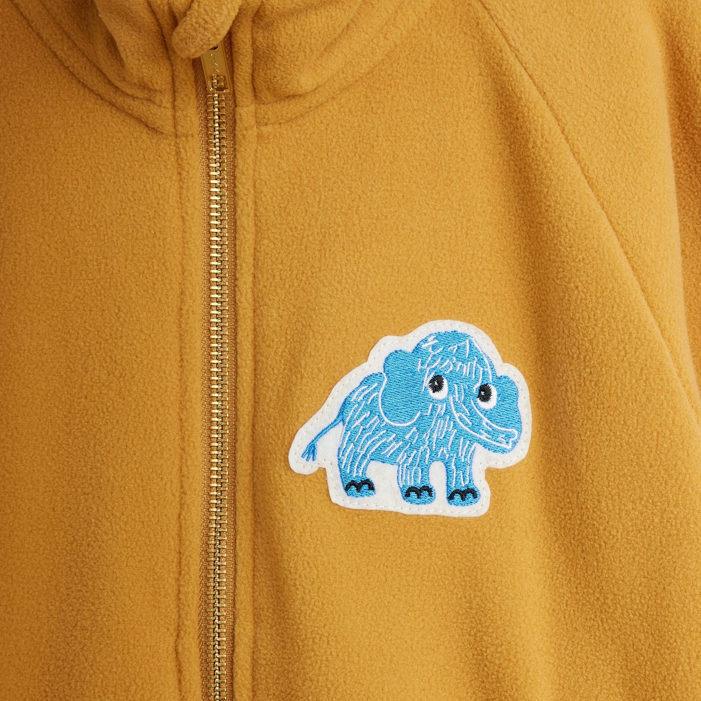 Yellow jacket with a blue and white mammoth patch on the chest