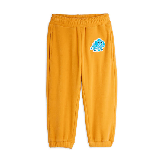 Yellow sweatpants with a blue cartoon character on a white background