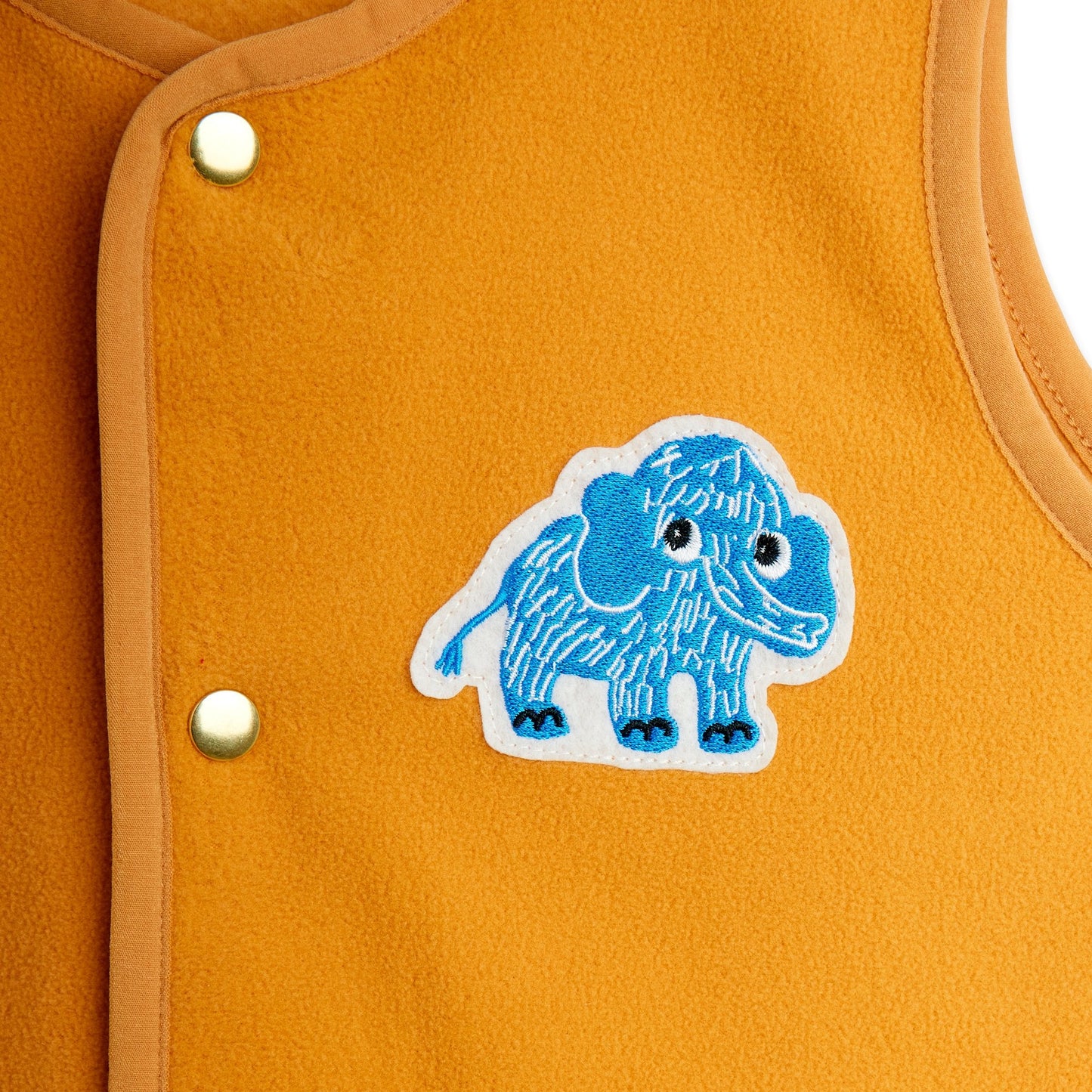 Blue mammoth patch on a mustard yellow background