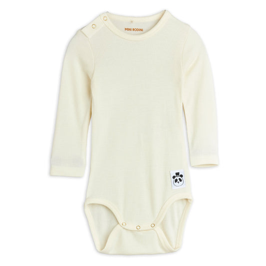 Cream-coloured baby onesie with a small logo on a white background