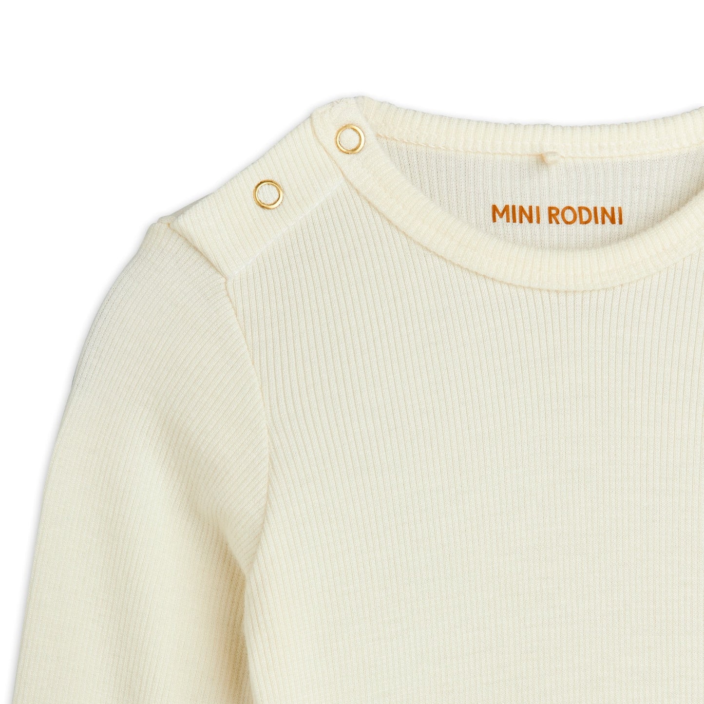 Close-up of a cream-coloured baby outfit with 'Mini Rodini' branding on a white background