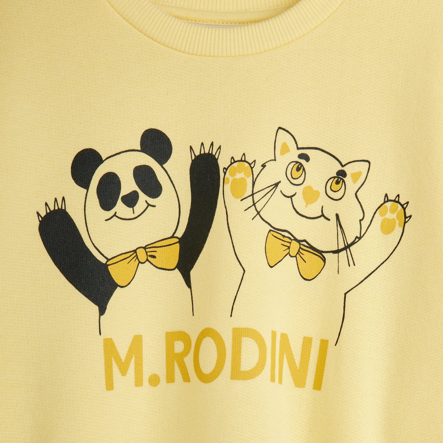 Yellow shirt with cartoon panda and cat design and 'M. Rodini' branding.