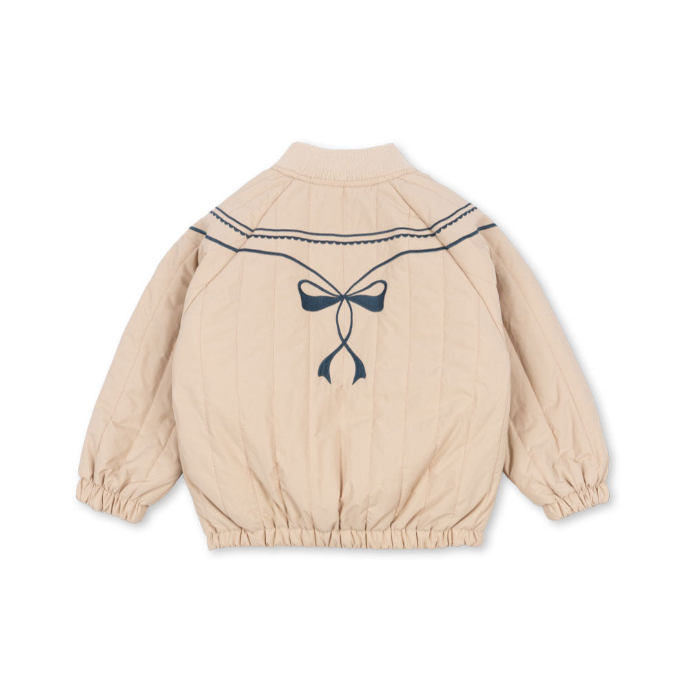 Beige children's jacket with a bow design on a white background