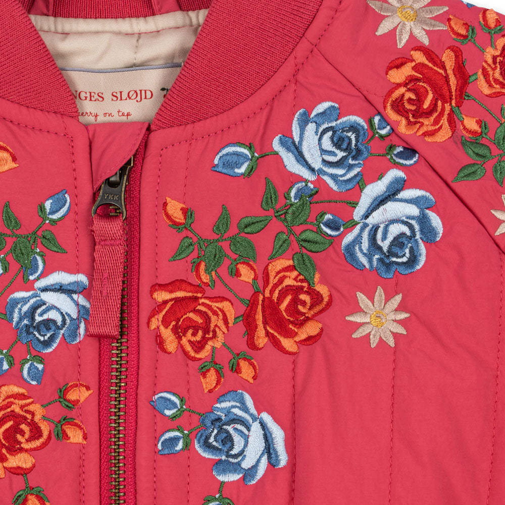 Red jacket with floral embroidery on a red background