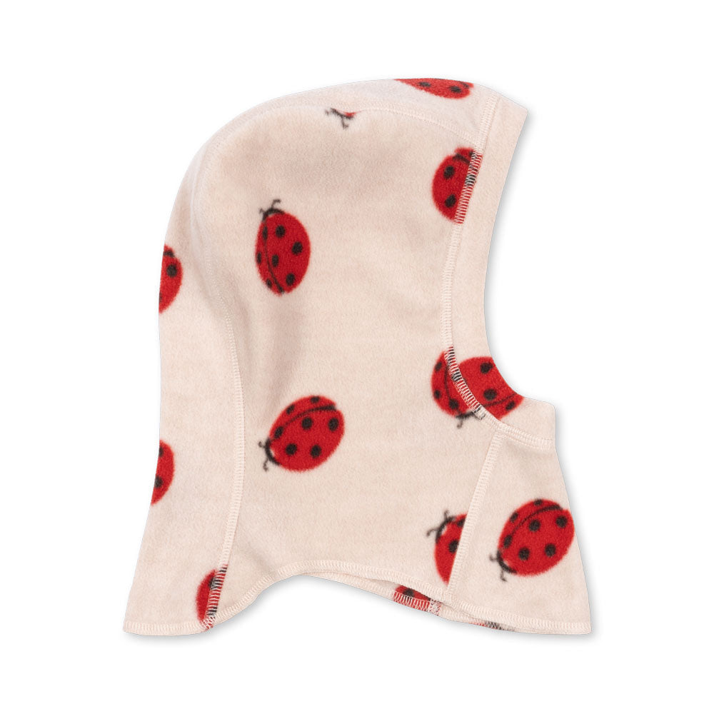 Beige fleece balaclava with red ladybug pattern on a white background