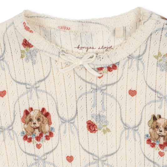 Textured fabric with embroidered dog and heart pattern, featuring the brand 'Longes & Lloyd'.