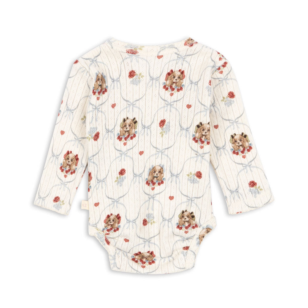 Floral patterned baby romper on a white background