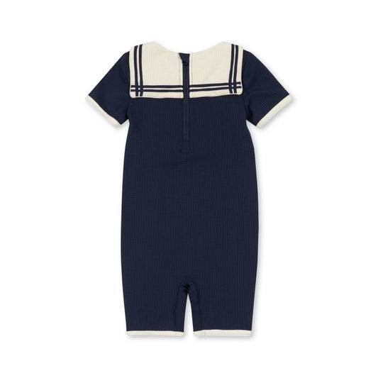 Navy blue romper swimsuit with white collar on a white background