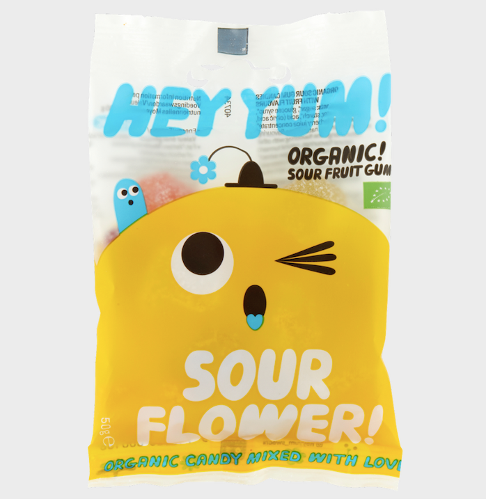 Packaging of HEY YUM! Organic Sour Fruit Gums, featuring a character design that resembles a flower, with the text 'SOUR FLOWER' on the package.
