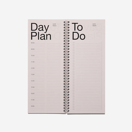 An open washed Pink spiral binder planner with the text - Day Plan and To Do written on the pages, placed on a white background.