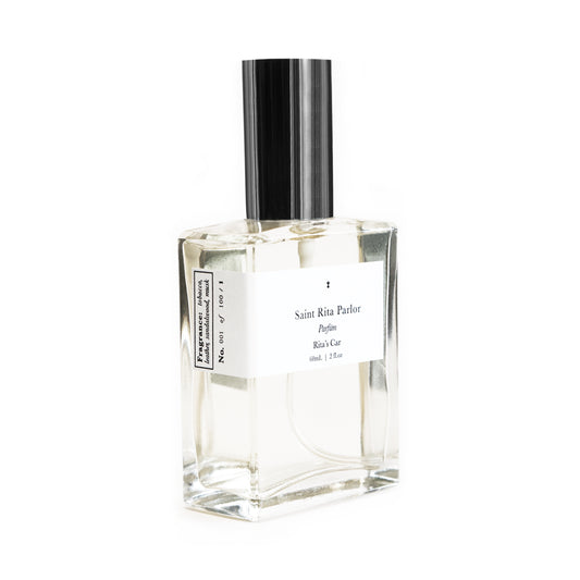 A clear glass bottle of Saint Rita Parlor perfume with a silver cap, labeled 'Rita's Car' with a volume of 60ml.