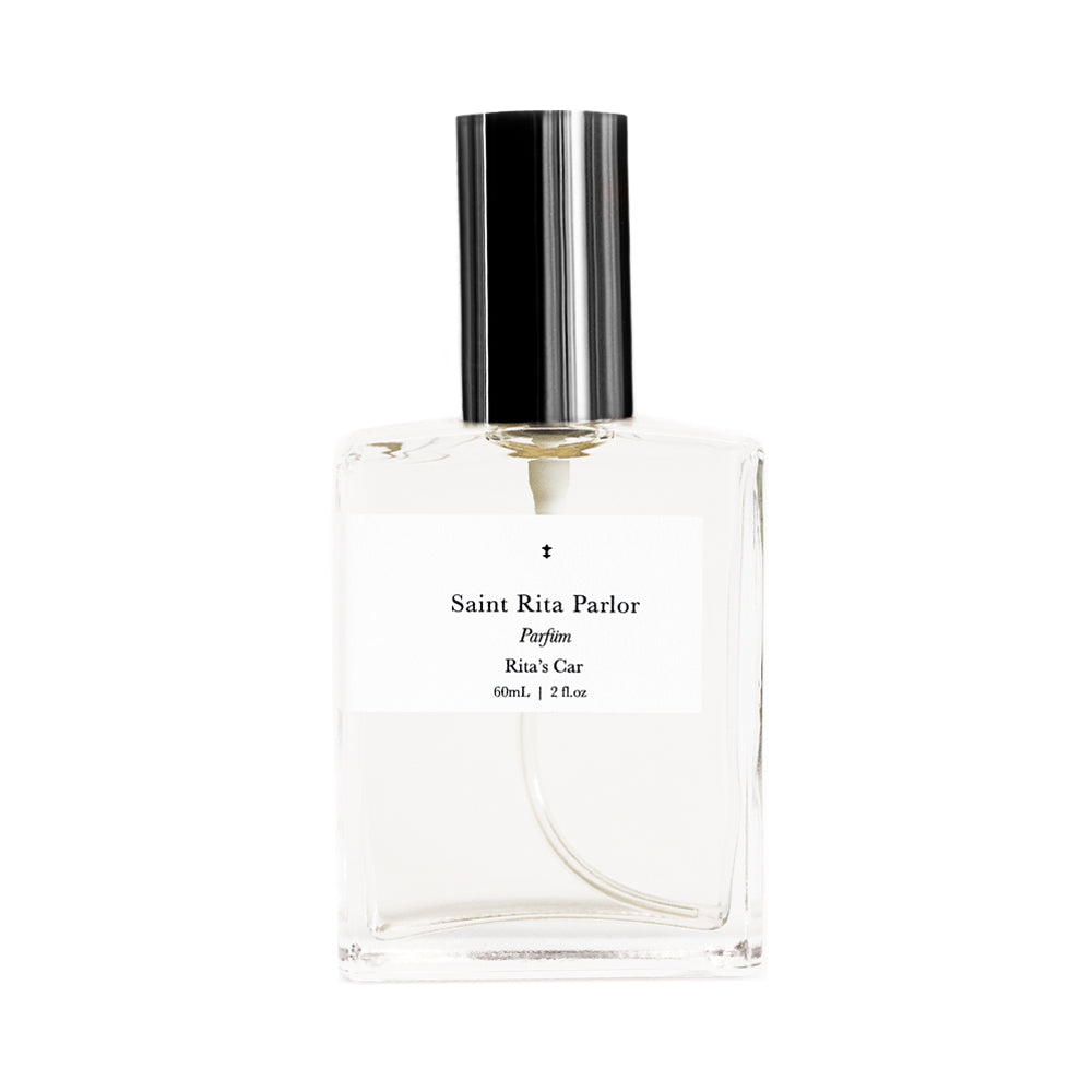 A clear glass bottle of Saint Rita Parlor perfume with a silver cap, labeled 'Rita's Car' with a volume of 60ml.