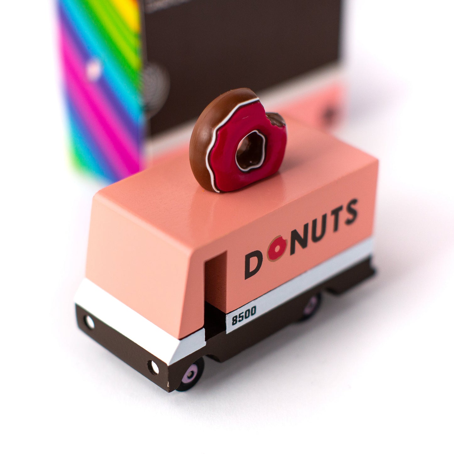 Toy truck with 'DONUTS' branding and a donut on top, set against a white background.
