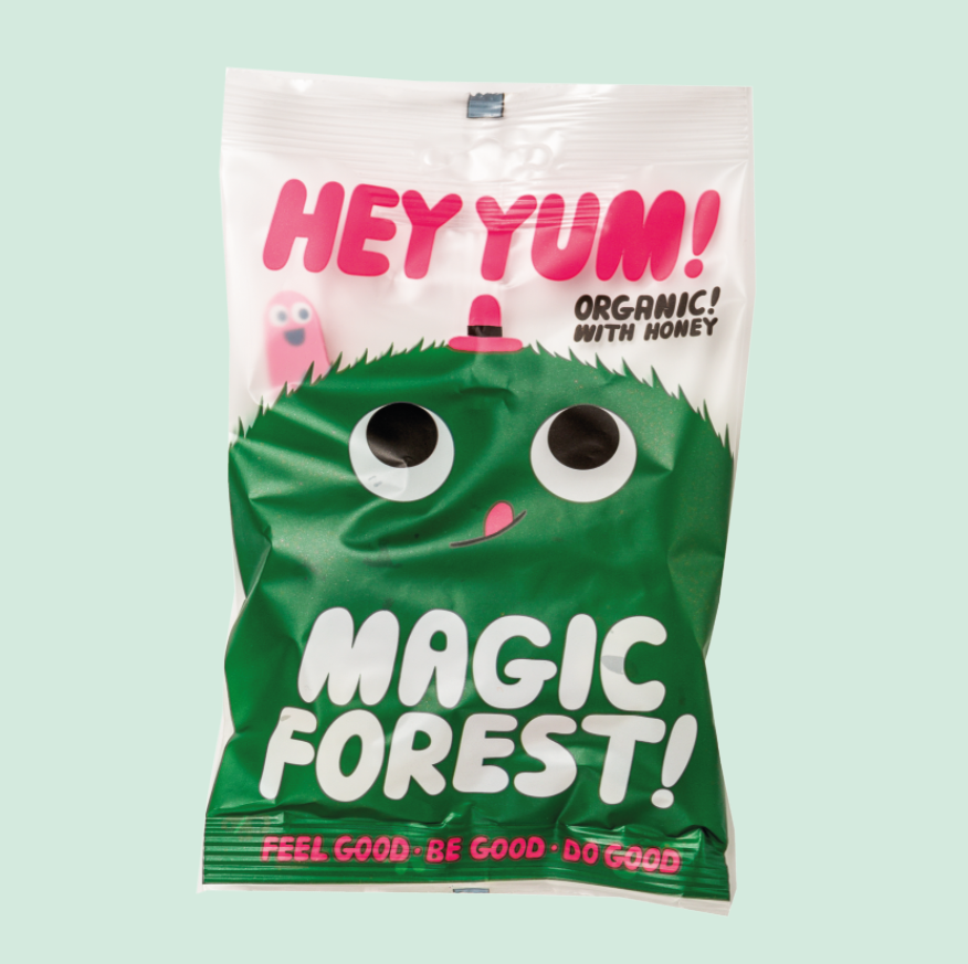 A package of HEY YUM! Magic Forest organic fruit gums featuring a green character and text on a white background.