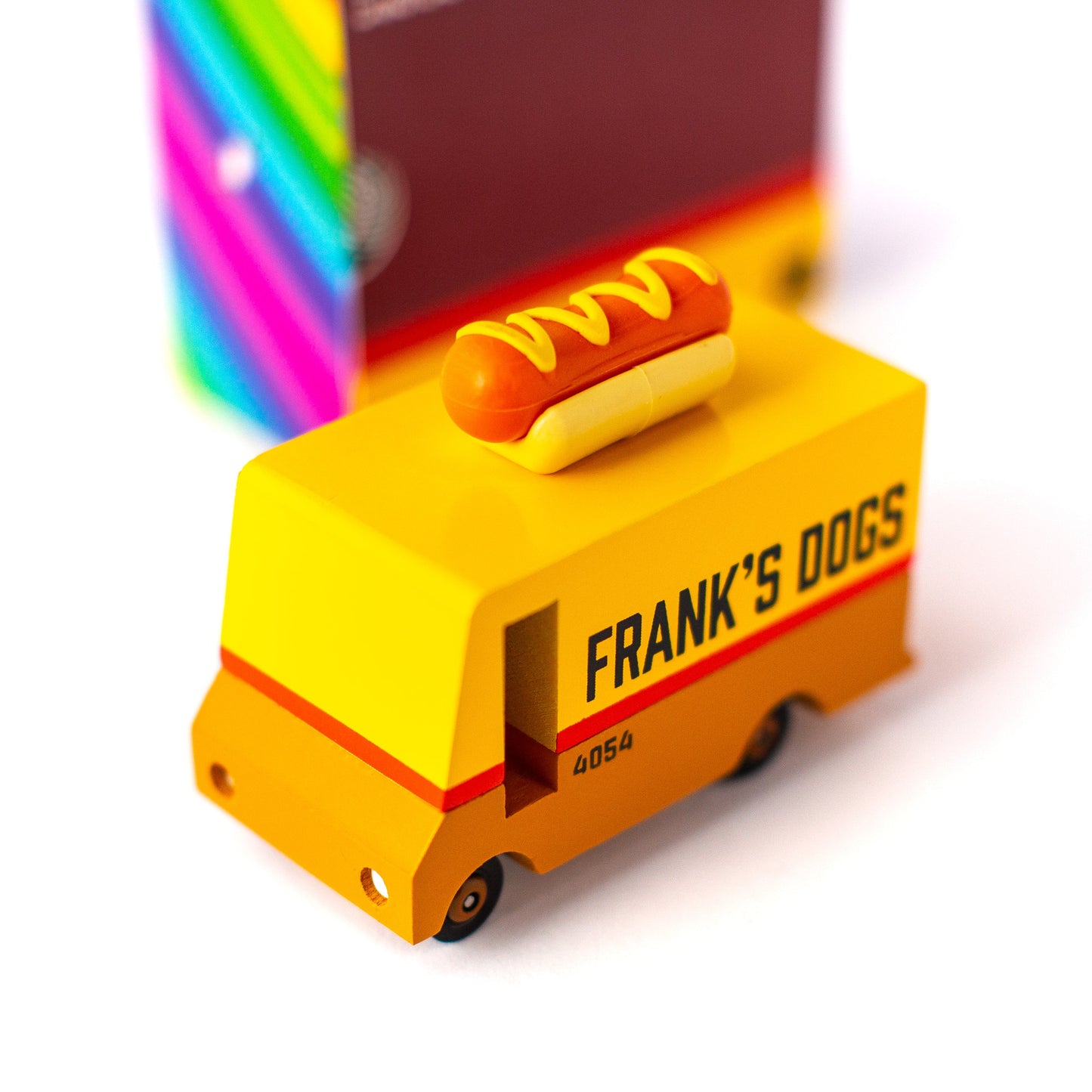 Toy hot dog cart with a hot dog on top, labeled 'Frank's Dogs', on a white background.