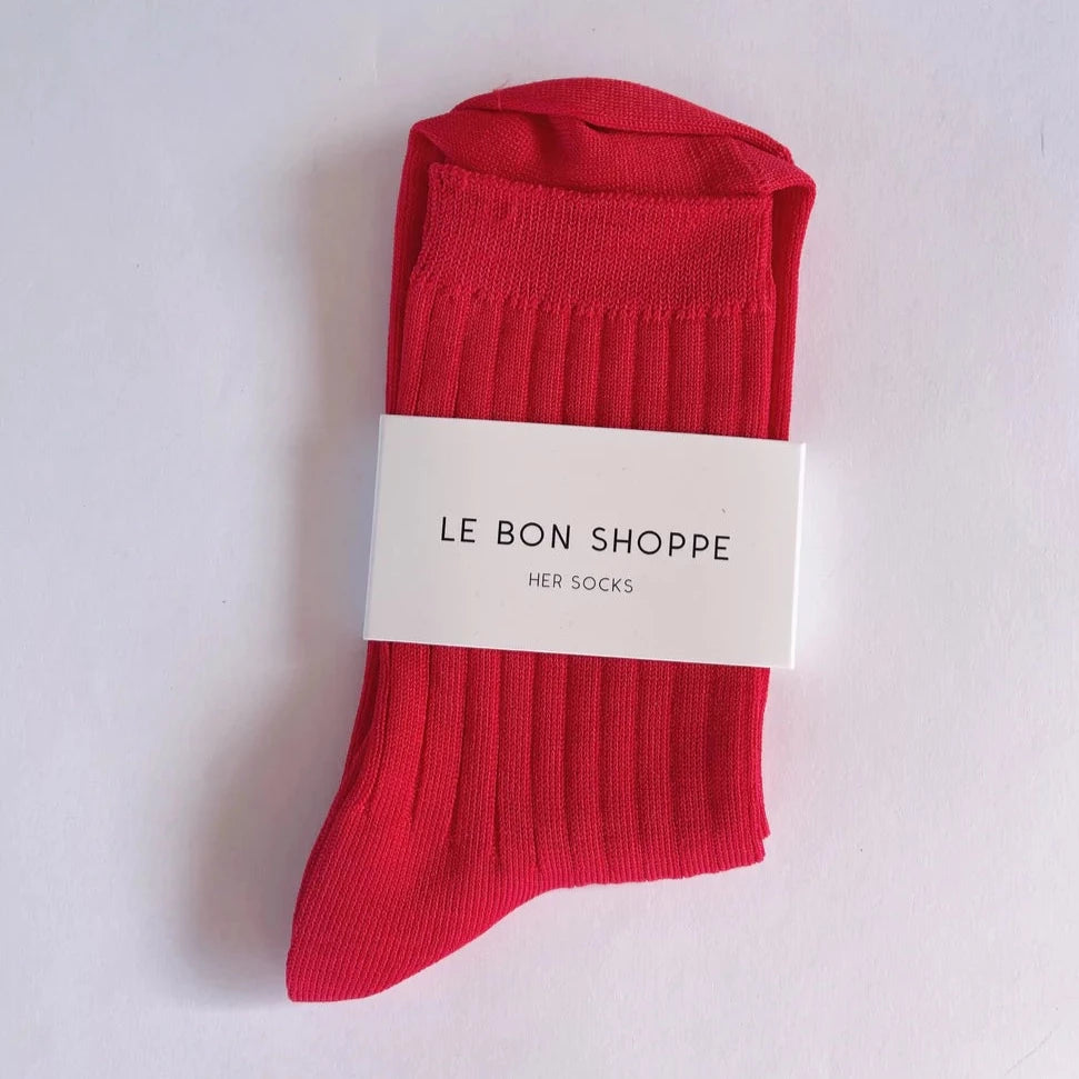 A pair of red Le Bon Shoppe socks with ribbed design, displayed on a white background with a brand tag attached.