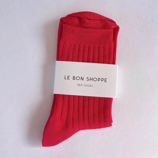 A pair of red Le Bon Shoppe socks with ribbed design, displayed on a white background with a brand tag attached.