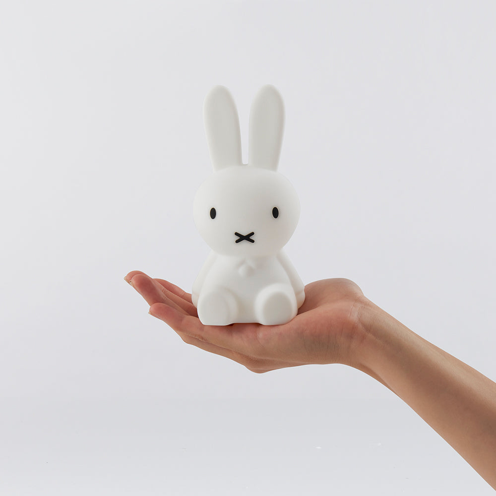 Miffy Bundle of Light Nightlight placed on the palm of a hand with a white background