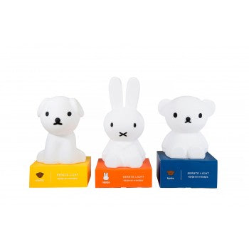 Three First Light Lamps placed on top of coloured cardboard boxes against a white background. The lamps are shaped like a puppy, rabbit and teddy bear