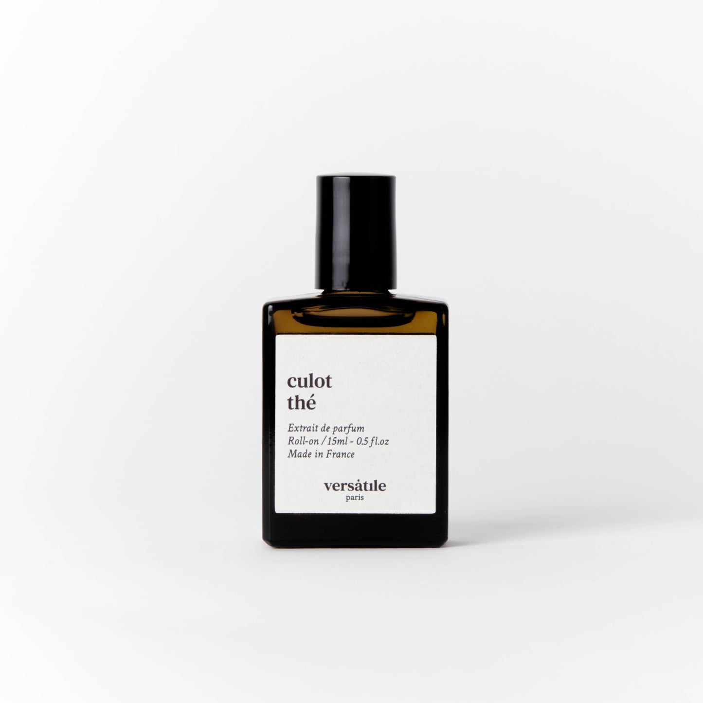 An image of a brown perfume bottle with a black screw on lid on it. The bottle has a square white label on it that says the scent of the perfume 'culot the' along with the amount of perfume in the bottle, that being 15ml and where the perfume was made, that being in France. Beneath this it says versatile Paris.