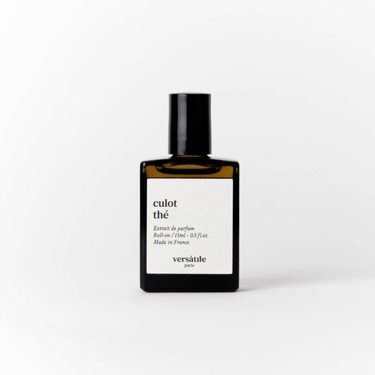 An image of a brown perfume bottle with a black screw on lid on it. The bottle has a square white label on it that says the scent of the perfume 'culot the' along with the amount of perfume in the bottle, that being 15ml and where the perfume was made, that being in France. Beneath this it says versatile Paris.